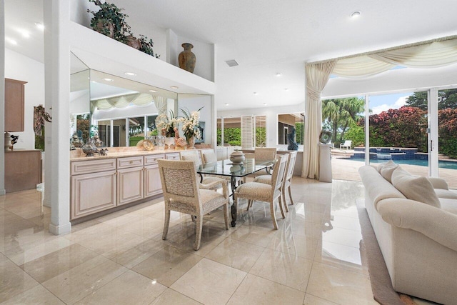 dining space with a towering ceiling