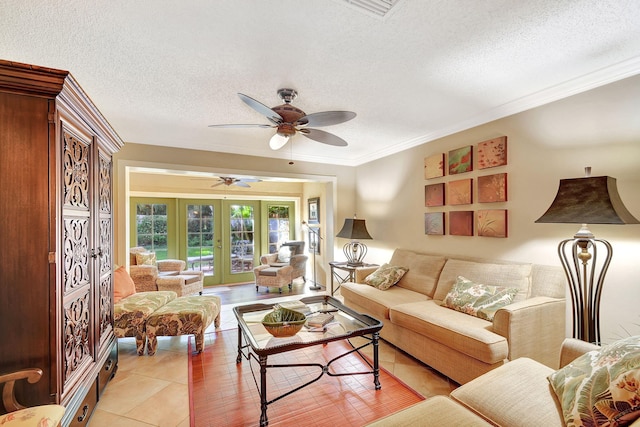 living room featuring french doors, ceiling fan, light tile patterned floors, and a textured ceiling