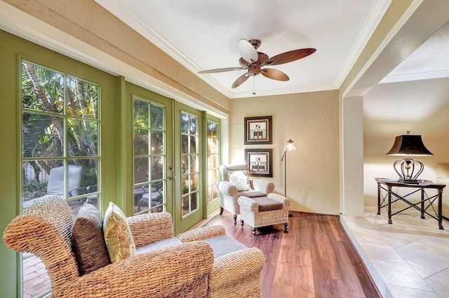 living area featuring ceiling fan, ornamental molding, tile patterned floors, and french doors