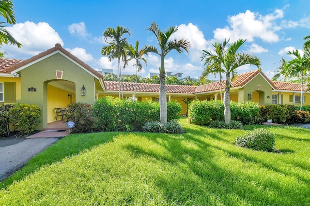 mediterranean / spanish-style home with a front yard