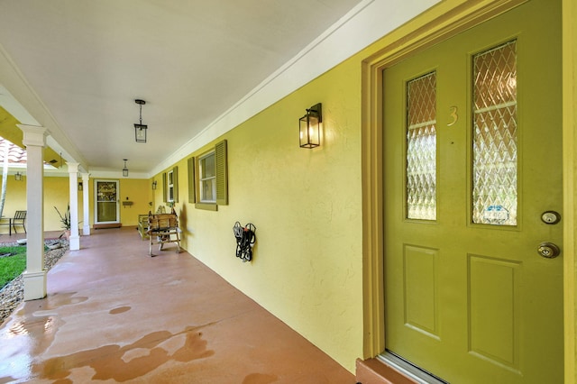 view of exterior entry with covered porch