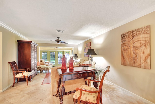 tiled dining room with a textured ceiling, ceiling fan, ornamental molding, and french doors