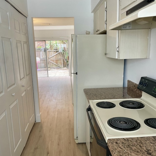 kitchen featuring white range with electric stovetop, white cabinets, and light hardwood / wood-style floors