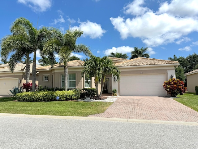 view of front of home featuring a garage and a front lawn