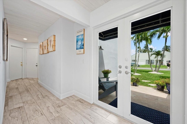 interior space with light wood-type flooring, french doors, and a healthy amount of sunlight