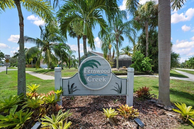 community / neighborhood sign with a lawn