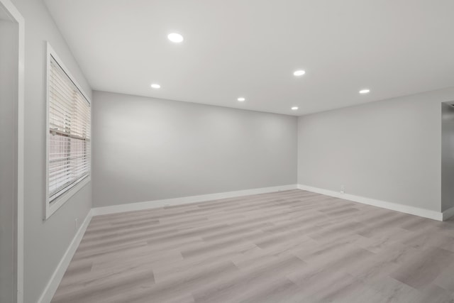 unfurnished room with light hardwood / wood-style flooring