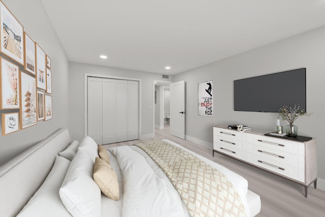 bedroom featuring light wood-type flooring and a closet