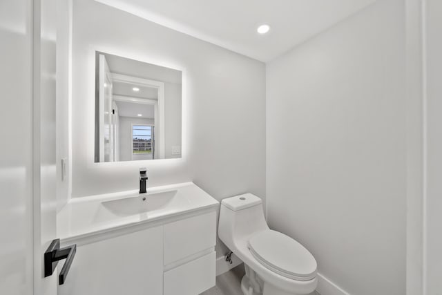 bathroom featuring toilet and vanity