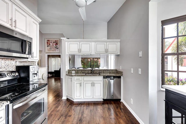 kitchen with white cabinets, stainless steel appliances, ceiling fan, dark hardwood / wood-style floors, and sink