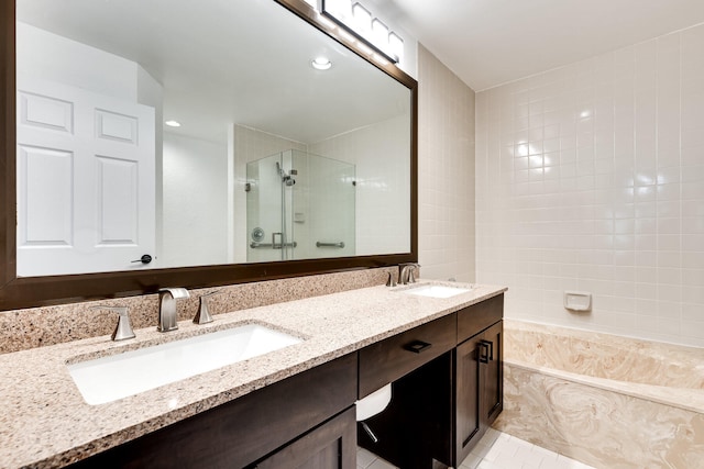 bathroom featuring independent shower and bath, vanity, and tile patterned floors