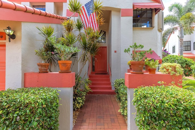 entrance to property featuring stucco siding