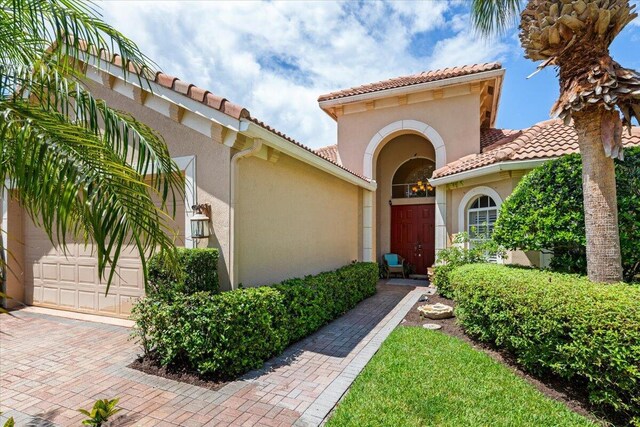 view of exterior entry with a garage