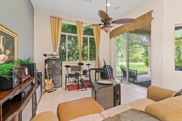 living room featuring ceiling fan, light tile patterned floors, and plenty of natural light