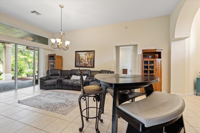 dining room featuring a chandelier and light tile patterned floors