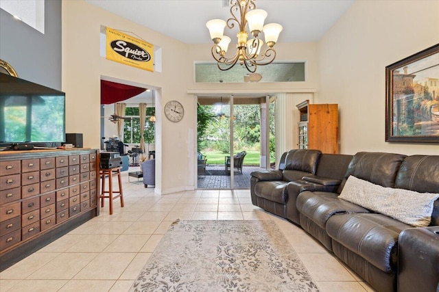 living room featuring an inviting chandelier, a towering ceiling, and light tile patterned flooring