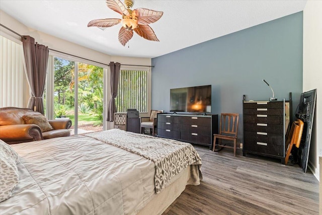 bedroom featuring ceiling fan, hardwood / wood-style flooring, and access to outside