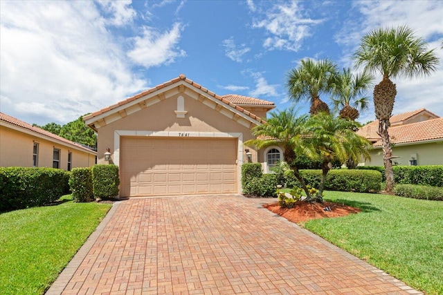 mediterranean / spanish-style house with a garage and a front yard