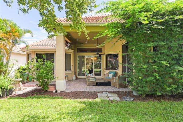 rear view of house with a patio area and a yard