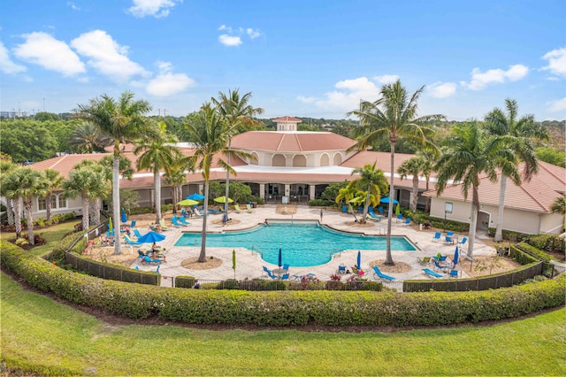 view of pool with a lawn and a patio