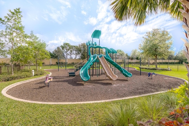 view of jungle gym featuring a lawn