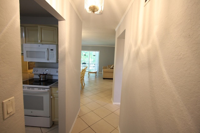 interior space featuring ornamental molding, light tile patterned floors, and white appliances