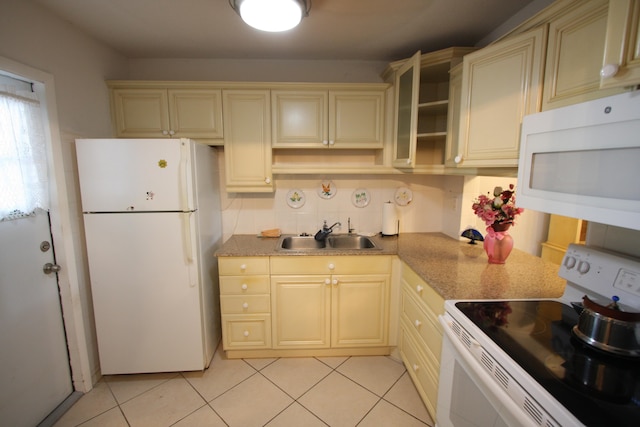 kitchen with white appliances, sink, cream cabinets, and decorative backsplash