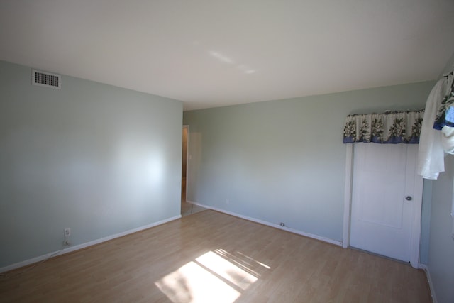 spare room with light hardwood / wood-style flooring