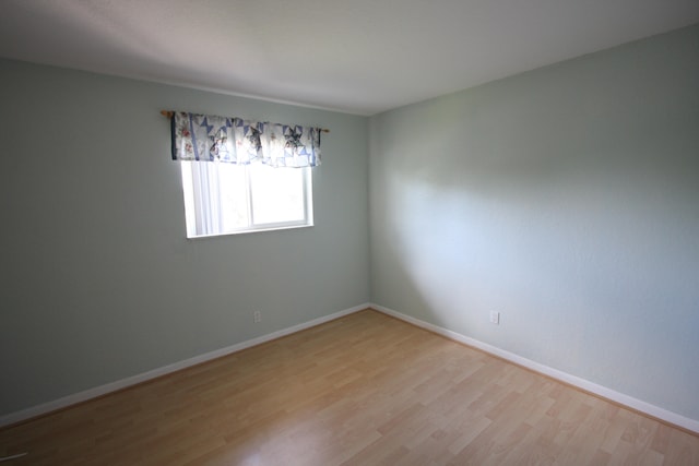 empty room with light hardwood / wood-style flooring