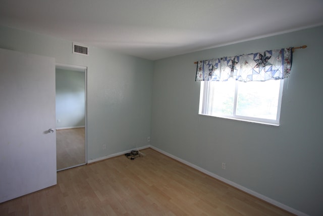 unfurnished room with light hardwood / wood-style flooring