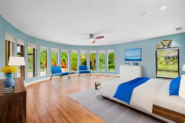 bedroom with hardwood / wood-style flooring and ceiling fan