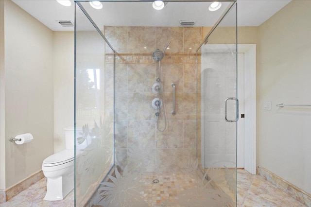 bathroom with toilet and a shower with door