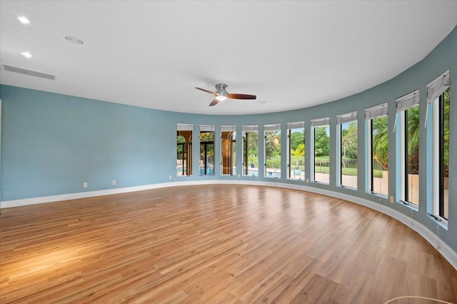 unfurnished room with ceiling fan and light hardwood / wood-style flooring