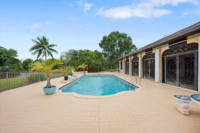 view of pool featuring french doors and a patio