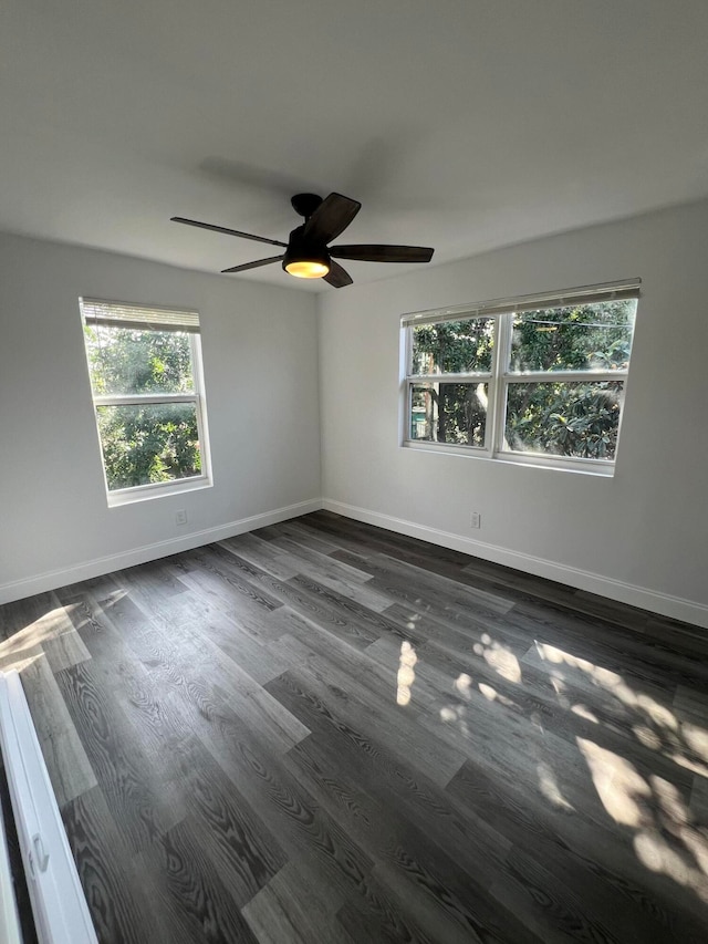 unfurnished room featuring ceiling fan and dark hardwood / wood-style floors