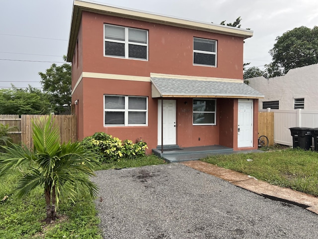 1010 Adams St, West Palm Beach, FL 33407 - view of front of home featuring stucco siding and roof with shingles