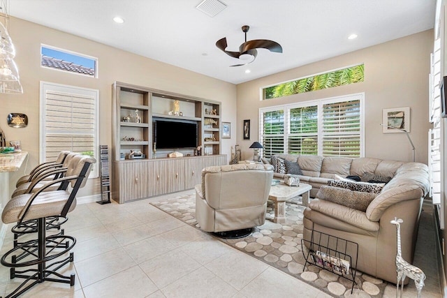 tiled living room with ceiling fan