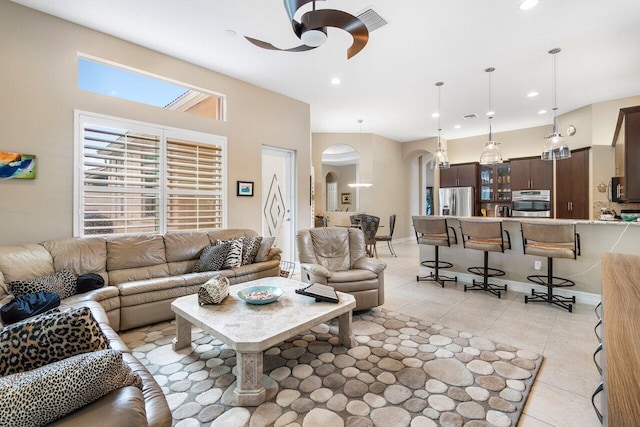 tiled living room featuring ceiling fan