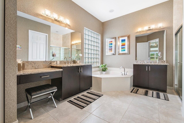 bathroom with tile patterned flooring, shower with separate bathtub, and vanity