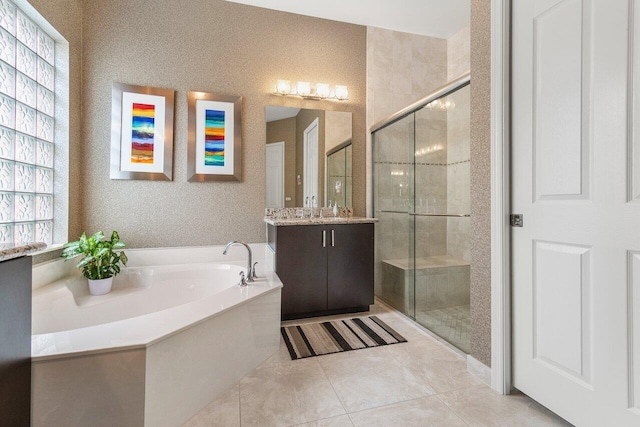 bathroom featuring vanity, independent shower and bath, and tile patterned floors