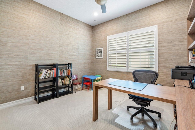 carpeted home office with ceiling fan