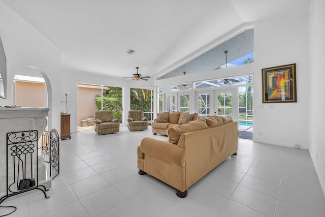 living room with ceiling fan, high vaulted ceiling, and light tile patterned floors