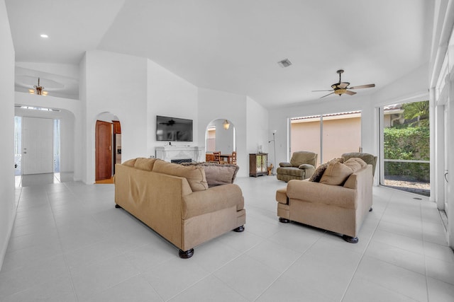 living room with light tile patterned floors, vaulted ceiling, and ceiling fan