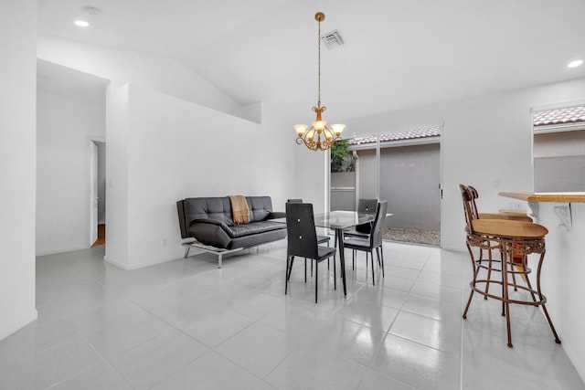 dining area with lofted ceiling, a notable chandelier, and light tile patterned floors