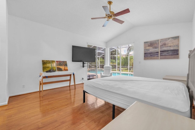 bedroom with lofted ceiling, wood-type flooring, access to outside, and ceiling fan