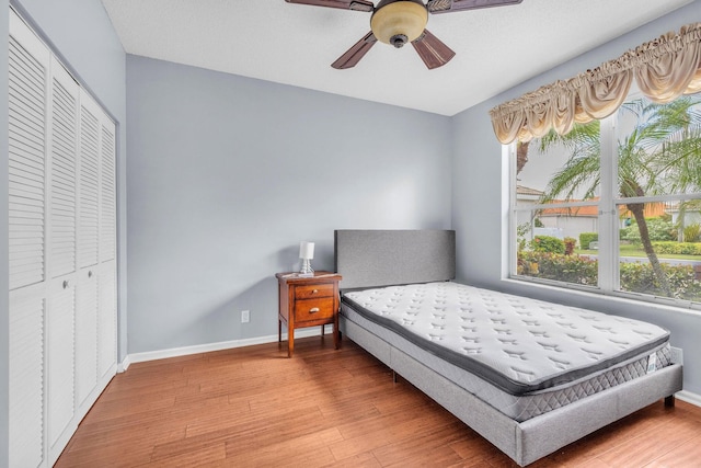 bedroom with a closet, ceiling fan, and wood-type flooring