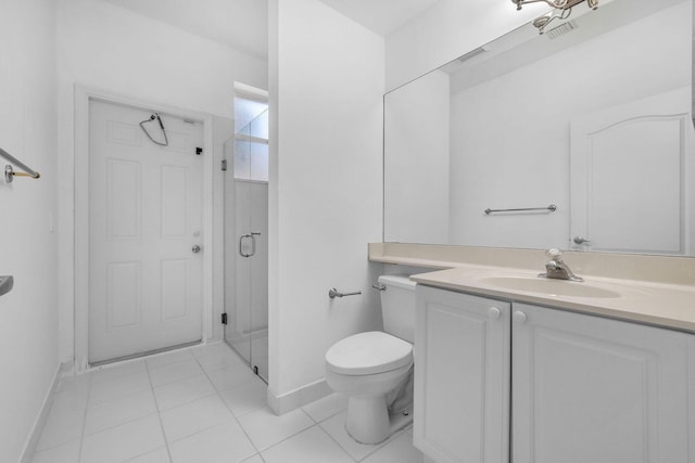 bathroom featuring vanity, tile patterned floors, toilet, and an enclosed shower