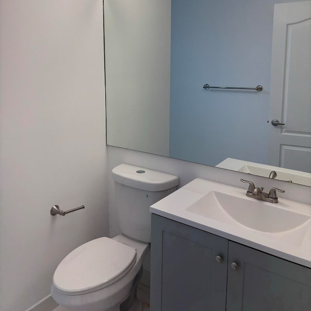 bathroom featuring vanity and toilet