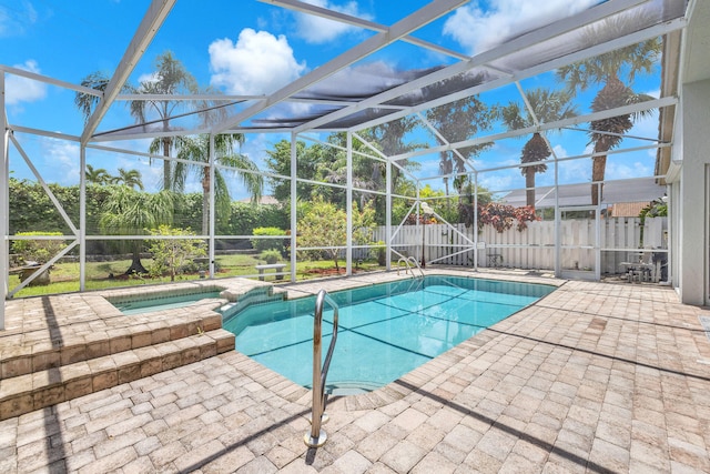 view of pool featuring an in ground hot tub, a patio area, and a lanai