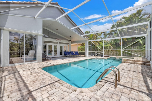 view of swimming pool with french doors, a patio, a lanai, and ceiling fan